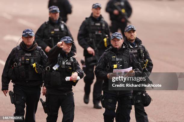 Armed Metropolitan Police officers on patrol ahead of the Coronation of King Charles III and Queen Camilla on May 06, 2023 in London, England. The...