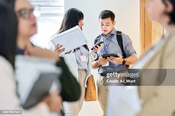 businesspeople exchanging their phone numbers in office corridor - phone number stock pictures, royalty-free photos & images