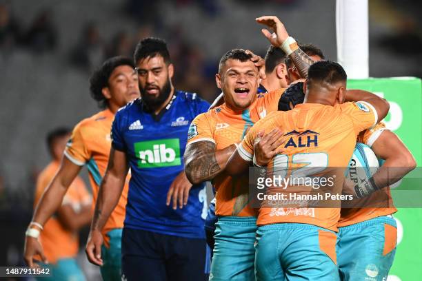 Christian Leali'ifano of Moana Pasifika celebrates after scoring a try with Levi Aumua during the round 11 Super Rugby Pacific match between the...