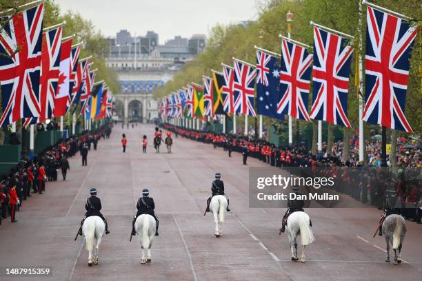 Mounted police officers can be seen on the Mall ahead of the Coronation of King Charles III and Queen Camilla on May 06, 2023 in London, England. The...