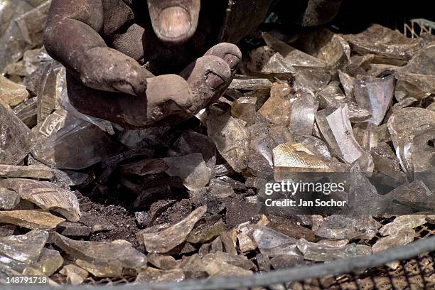 Nicaraguan man recollects glass cullets for recycling in the garbage dump La Chureca, on 04 November 2004 in Managua, Nicaragua. La Chureca is the...