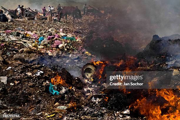 Nicaraguan garbage recollectors work among the burning piles of garbage in the garbage dump La Chureca on 09 November 2004 in Managua, Nicaragua. La...