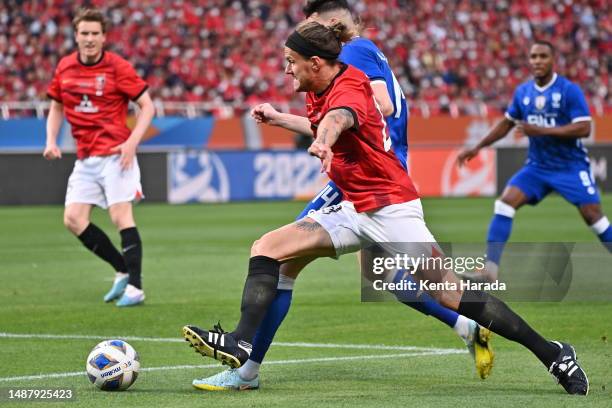 Of Urawa Reds and Player of Al Hilal Saudi FC compete for the ball during the AFC Champions League final second leg between Urawa Red Diamonds and...