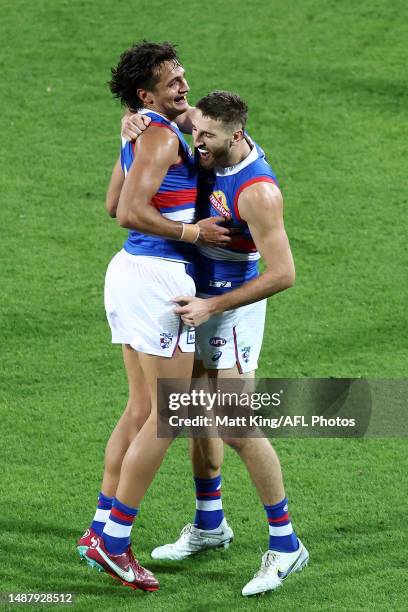 Marcus Bontempelli of the Bulldogs celebrates with Jamarra Ugle-Hagan of the Bulldogs after kicking a goal during the round eight AFL match between...