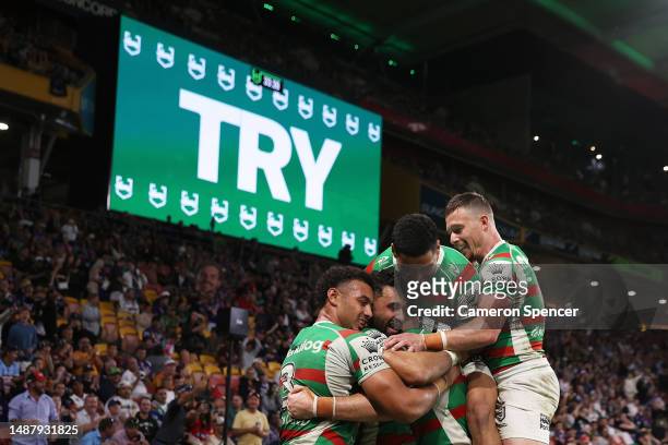 Alex Johnston of the Rabbitohs celebrates scoring a try with team mates during the round 10 NRL match between Melbourne Storm and South Sydney...