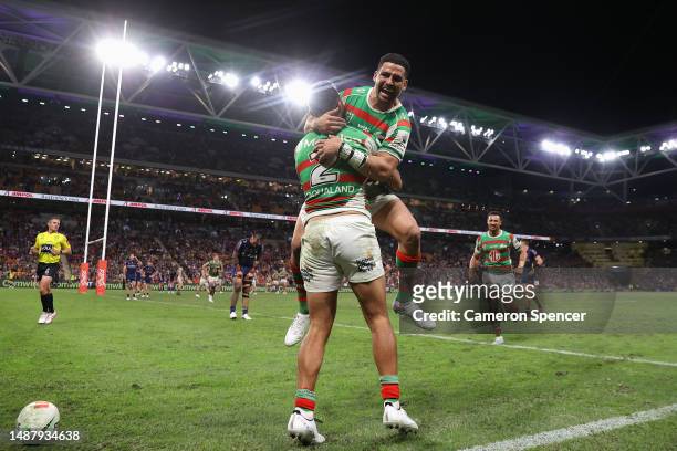Alex Johnston of the Rabbitohs celebrates scoring a try with Cody Walker of the Rabbitohs during the round 10 NRL match between Melbourne Storm and...