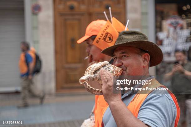 Man blows a conch shell at a demonstration called by the Hunting Federation of the Valencian Community, on May 6 in Valencia, Valencian Community,...