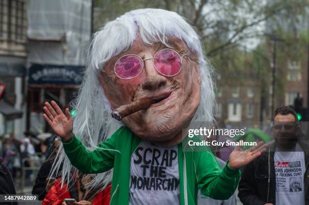 The lead singer of The Krown Jewelz attends the coronation celebrations in a giant Jimmy Savile mask to promote their new single 'Scrap the Monarchy'...