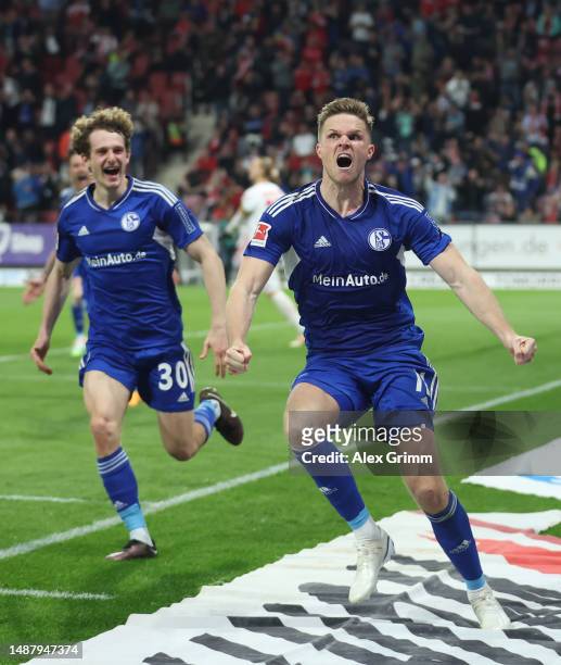 Marius Bulter of Schalke celebrates scoring his teams third goal of the game from the penalty spot with teammate Alex Kral of Schalke during the...