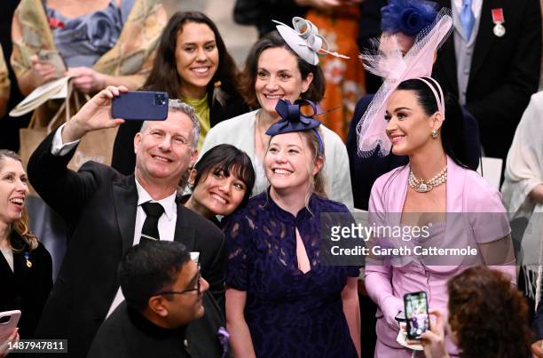 Katy Perry poses for selfies with Adam Hills and guests during the Coronation of King Charles III and Queen Camilla on May 06, 2023 in London,...
