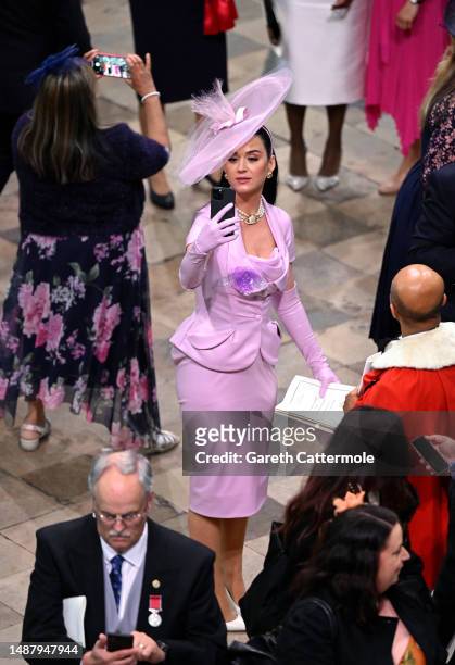 Katy Perry takes selfies during the Coronation of King Charles III and Queen Camilla on May 06, 2023 in London, England. The Coronation of Charles...
