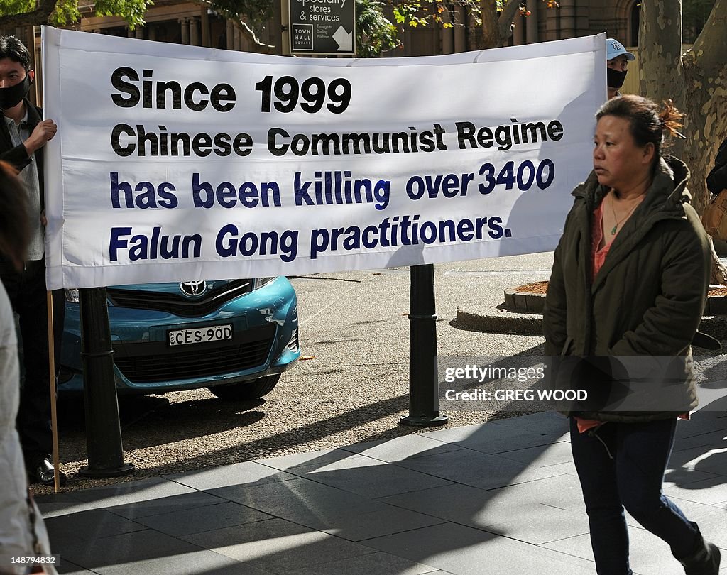 A woman walks past a banner as practitio