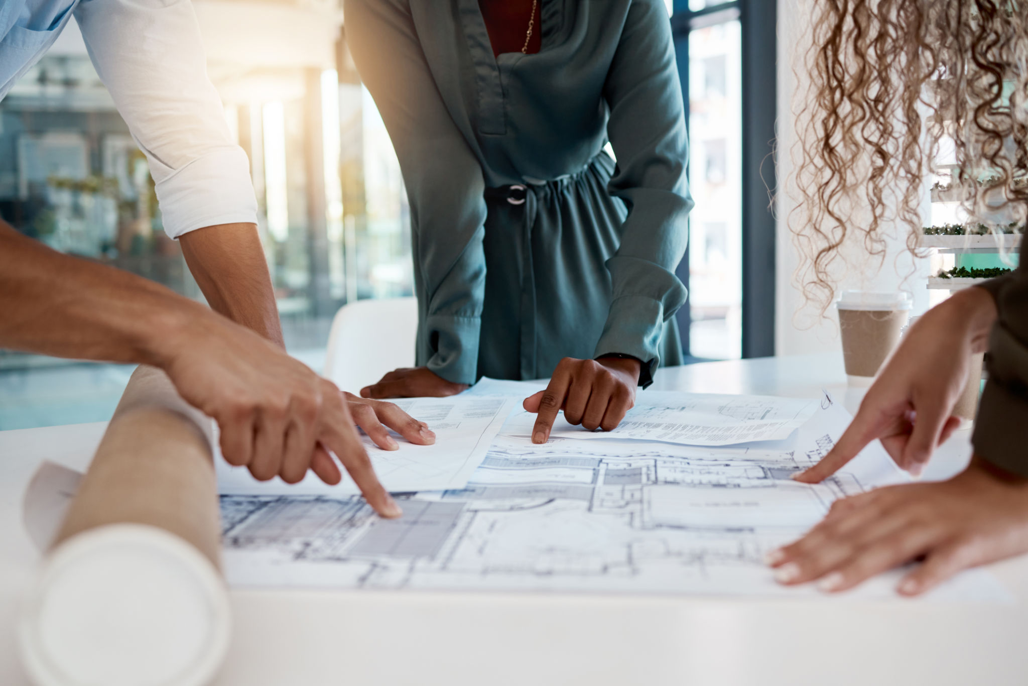 Architecture, engineering team and hands with blueprint for planning, building strategy and meeting. Construction site, property development and contractors with illustration, design and floor plan Architecture, engineering team and hands with blueprint for planning, building strategy and meeting. Construction site, property development and contractors with illustration, design and floor plan
