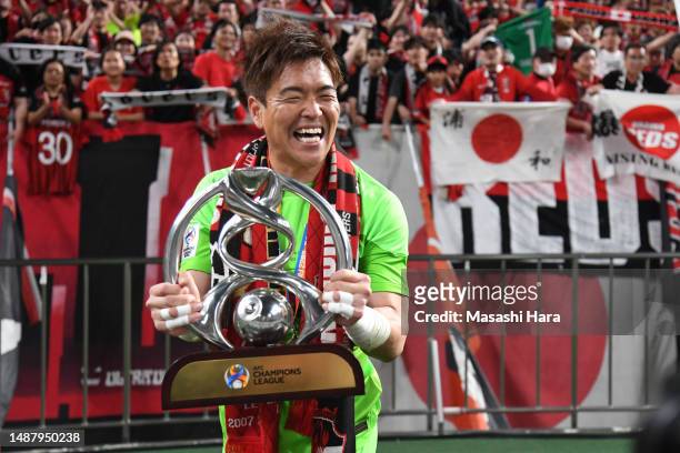 Shusaku Nishikawa of Urawa Reds holds the trophy after the AFC Champions League final second leg between Urawa Red Diamonds and Al-Hilal at Saitama...
