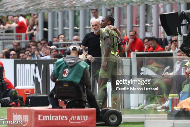 Stefano Pioli, Head Coach of AC Milan, interacts with Rafael Leao of AC Milan after he leaves the pitch with an injury during the Serie A match...