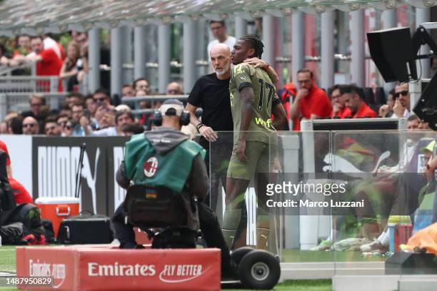 Stefano Pioli, Head Coach of AC Milan, interacts with Rafael Leao of AC Milan after he leaves the pitch with an injury during the Serie A match...