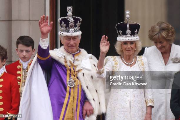 King Charles III and Queen Camilla can be seen on the Buckingham Palace balcony ahead of the flypast during the Coronation of King Charles III and...