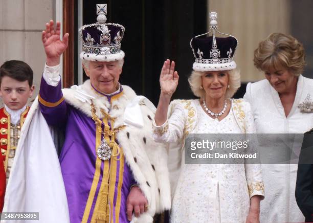 King Charles III and Queen Camilla can be seen on the Buckingham Palace balcony ahead of the flypast during the Coronation of King Charles III and...