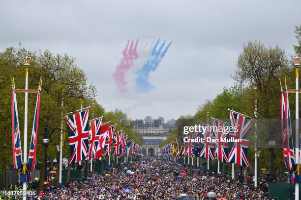 The Royal Air Force Aerobatic Team otherwise known as The Red Arrows fly over The Mall during the Coronation of King Charles III and Queen Camilla on...