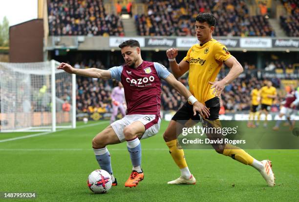 Alex Moreno of Aston Villa is put under pressure by Matheus Nunes of Wolverhampton Wanderers during the Premier League match between Wolverhampton...