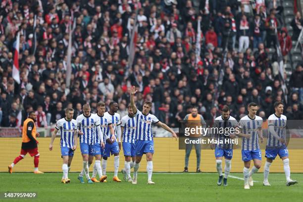 Marc-Oliver Kempf of Hertha Berlin celebrates alongside teammates after scoring the team's first goal during the Bundesliga match between Hertha BSC...