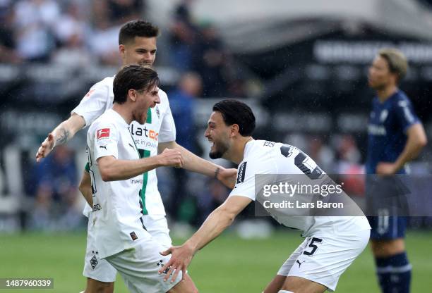 Jonas Hofmann of Borussia Moenchengladbach celebrates with teammate Ramy Bensebaini after scoring the team's first goal during the Bundesliga match...
