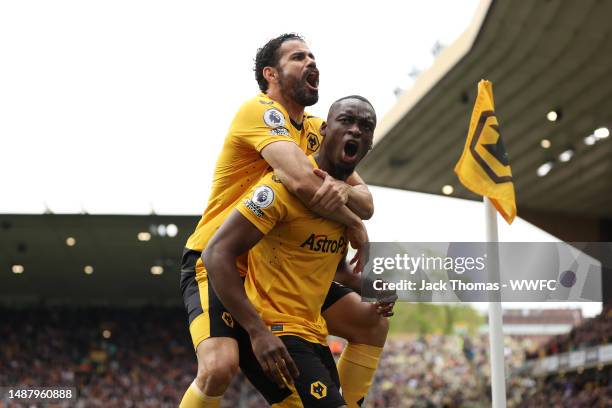 Toti Gomes of Wolverhampton Wanderers celebrates with Diego Costa after scoring the team's first goal during the Premier League match between...