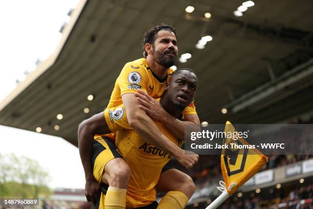 Toti Gomes of Wolverhampton Wanderers celebrates with Diego Costa after scoring the team's first goal during the Premier League match between...