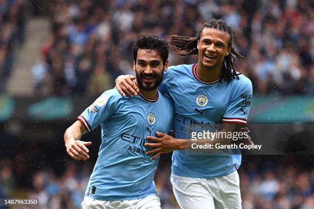 Ilkay Guendogan of Manchester City celebrates with team mate Nathan Ake after scoring their sides second goal during the Premier League match between...