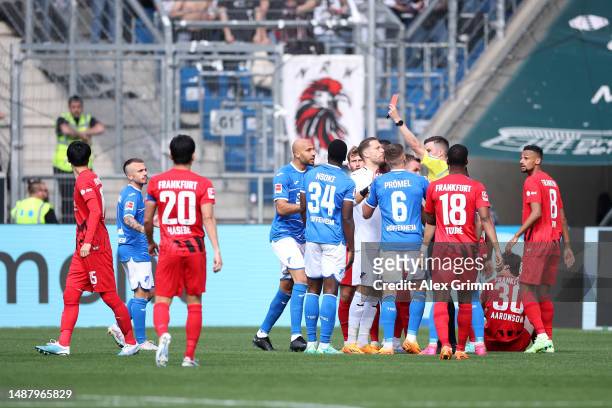 Stanley Nsoki of TSG Hoffenheim is shown a red card from Match Referee Harm Osmers during the Bundesliga match between TSG Hoffenheim and Eintracht...