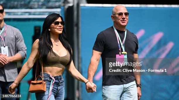 Jeff Bezos and Lauren Sanchez walk in the Paddock prior to final practice ahead of the F1 Grand Prix of Miami at Miami International Autodrome on May...