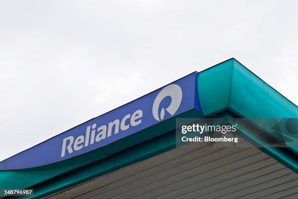 The Reliance Industries Ltd. Logo is displayed atop the company's gas station in Mumbai, India, on Thursday, July 19, 2012. Reliance Industries Ltd....