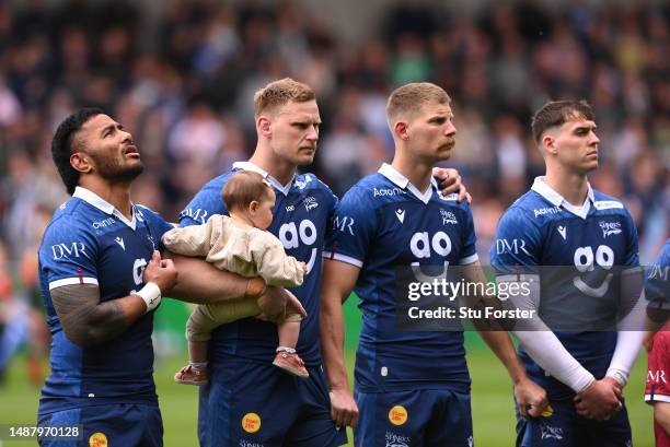 Manu Tuilagi of the Sharks sings the national anthem alongside team mates during the Gallagher Premiership Rugby match between Sale Sharks and...