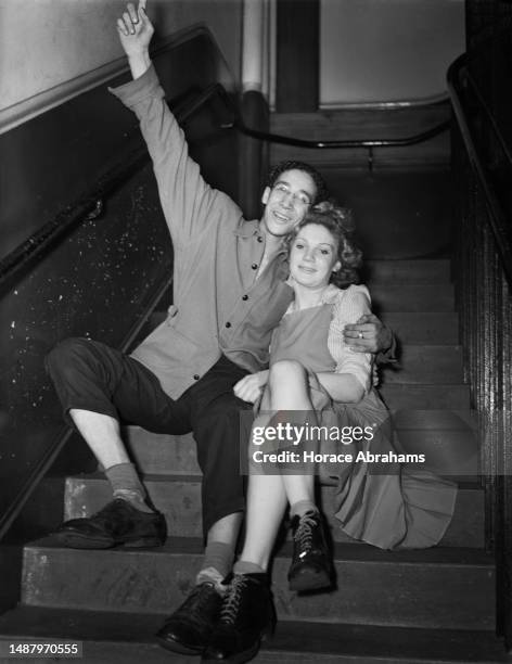 Prince Monolulu, his arm raised in triumph, and his partner Gladys Price celebrate after winning the All-London Jitterbug Championship, sitting on a...