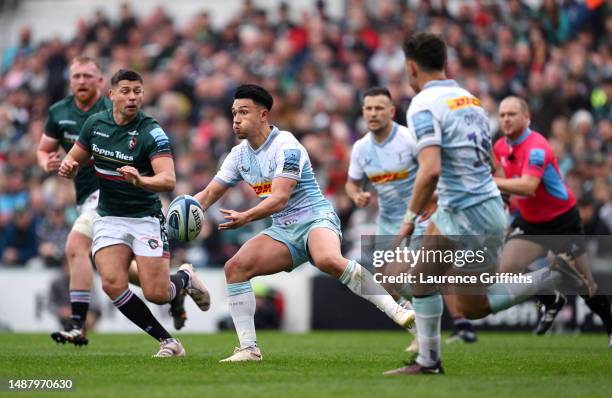 Marcus Smith of Harlequins passes the ball under pressure from Ben Youngs of Leicester Tigers the National Anthem during the Gallagher Premiership...