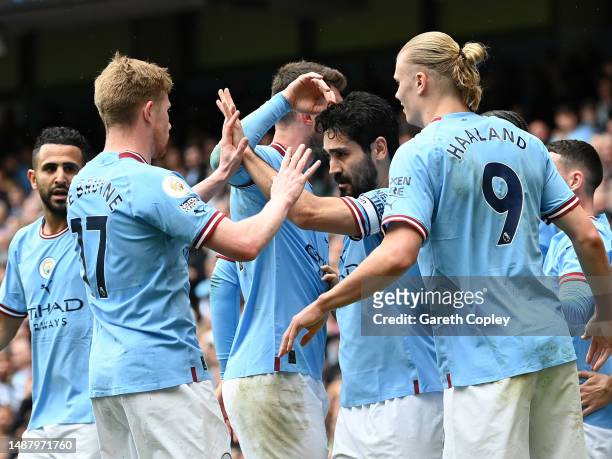 Ilkay Guendogan of Manchester City celebrates with Kevin De Bruyne and Erling Haaland after scoring the team's first goal during the Premier League...