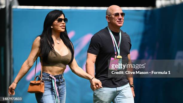 Jeff Bezos and Lauren Sanchez walk in the Paddock prior to final practice ahead of the F1 Grand Prix of Miami at Miami International Autodrome on May...