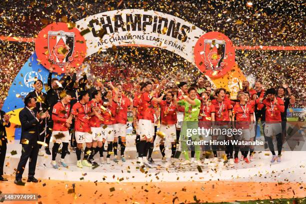 Players of Urawa Red Diamonds celebrate with the trophy after the AFC Champions League final second leg between Urawa Red Diamonds and Al-Hilal at...