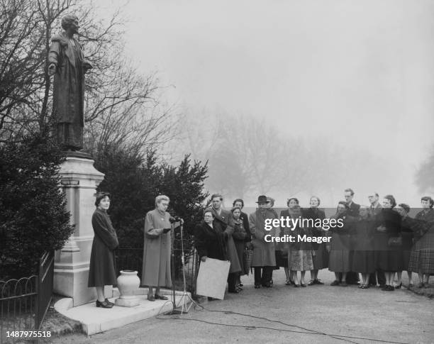 Chair of the Equal Pay Co-Ordinating Committee Muriel Coult looks on as Bobbie Peacock reads out an 'Equal Pay for Women' proclamation to protesters...