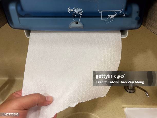 hands free hand paper towel dispenser - towel dispenser stock pictures, royalty-free photos & images