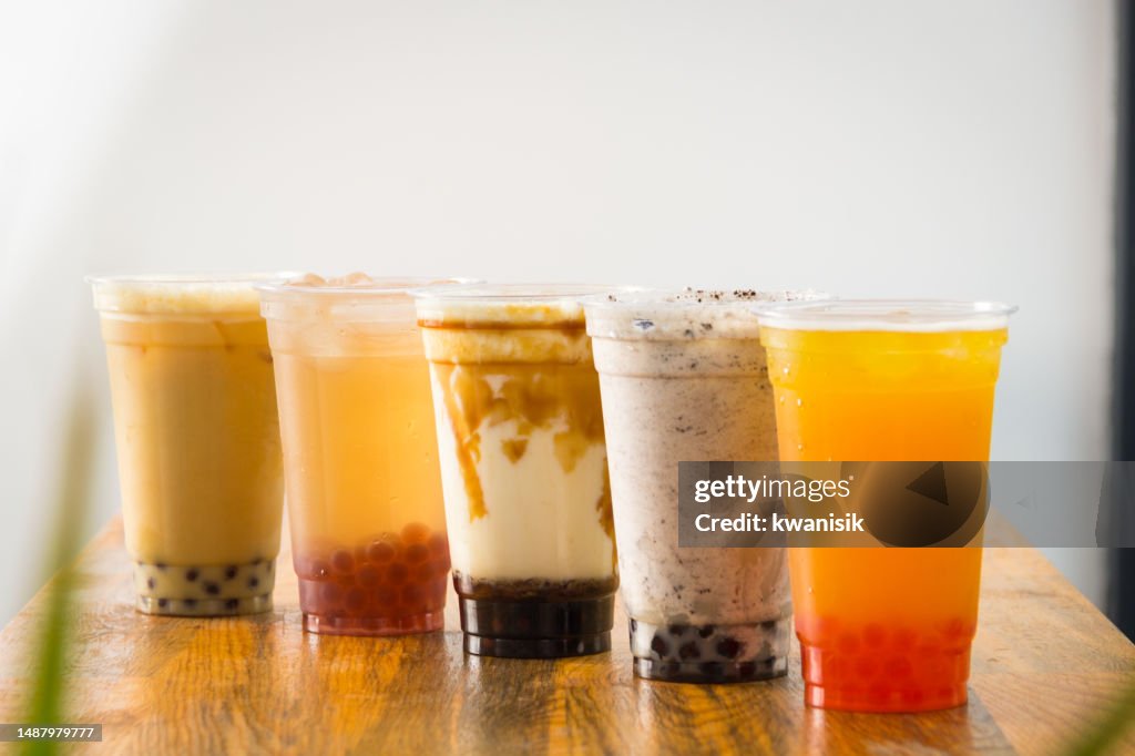 Fruit Bubble Teas - Pineapple, orange, strawberry and transparent Bubble Teas on the table