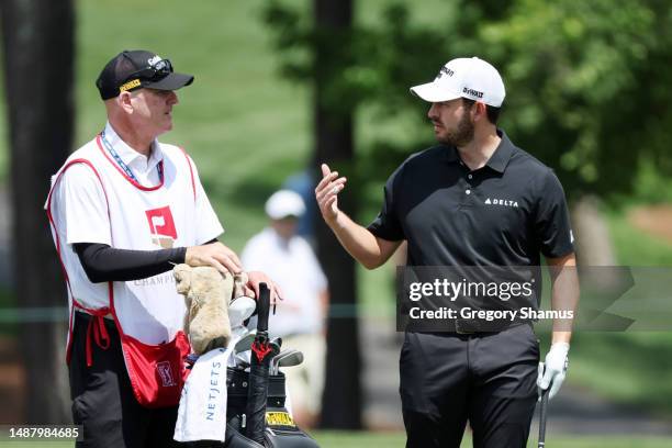 Patrick Cantlay of the United States talks with his caddie Joe LaCava on the fifth hole during the third round of the Wells Fargo Championship at...