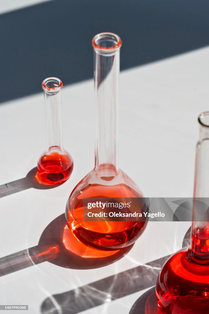 Flasks with red liquidin soft focus. Science research.