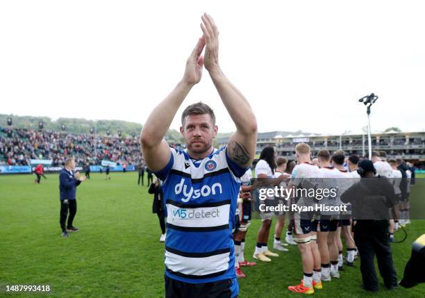 Dave Attwood of Bath Rugby applauds the fans after leading the team through a tunnel formed by players of Saracens after making their final career...