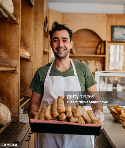 baker with fresh pastries - baker stock pictures, royalty-free photos & images
