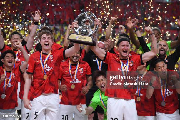 Alexander Scholz and Marius Hoibraten of Urawa Reds lift the trophy after the AFC Champions League final second leg between Urawa Red Diamonds and...