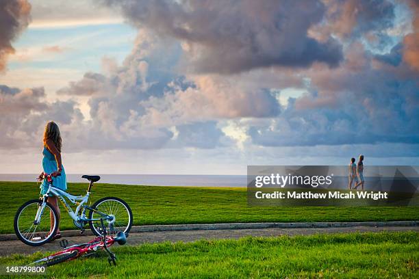 woman with bike on path through makai golf course. - princeville stock pictures, royalty-free photos & images