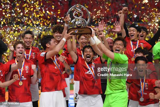Hiroki Sakai and Shusaku Nishikawa of Urawa Reds lift the trophy after the AFC Champions League final second leg between Urawa Red Diamonds and...