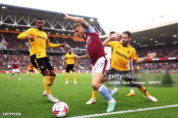 Lucas Digne of Aston Villa battles for possession against Joao Moutinho of Wolverhampton Wanderers during the Premier League match between...