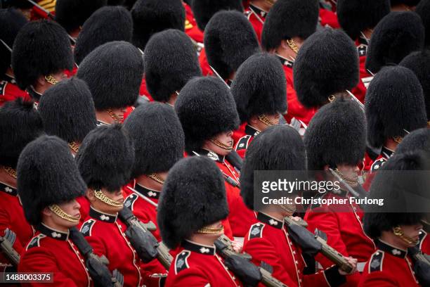 Coldstream Guards march in the rain during the Coronation of King Charles III and Queen Camilla on May 06, 2023 in London, England. The Coronation of...